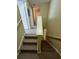 Carpeted stairs with wood banister leading to the upper level of the house at 4010 Santa Maria Dr # 106, Kissimmee, FL 34741