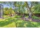Lush backyard with a stone bench and mature trees, creating a peaceful and inviting outdoor space at 424 Curry Ct, Altamonte Springs, FL 32714