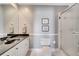 This full bathroom features a shower, a vanity with a black countertop, and bright white tile at 424 Curry Ct, Altamonte Springs, FL 32714