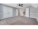 This expansive bedroom is finished with wall trim, plush carpet, and access to a walk-in closet at 424 Curry Ct, Altamonte Springs, FL 32714