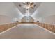 Vaulted ceilings and carpet throughout make this bonus room a flexible space for storage and hobbies at 424 Curry Ct, Altamonte Springs, FL 32714