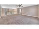 A large bonus room with plush carpeting featuring an open layout, ceiling fan and access to the upstairs hallway at 424 Curry Ct, Altamonte Springs, FL 32714