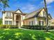 Elegant home boasting a manicured lawn, mature hedges, and a stately entrance with grand architectural details at 424 Curry Ct, Altamonte Springs, FL 32714