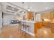 Stylish kitchen features light wood cabinets, granite countertops, an island with seating, and stainless-steel appliances at 424 Curry Ct, Altamonte Springs, FL 32714