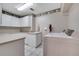Laundry room with utility sink, white cabinetry, and a front-load washing machine and dryer at 424 Curry Ct, Altamonte Springs, FL 32714
