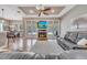 Cozy living room with a fireplace, hardwood floors, recessed lights, and views of the screened-in pool at 424 Curry Ct, Altamonte Springs, FL 32714