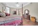 A spacious main bedroom features a tray ceiling, four-poster bed, dark wood floors and matching dresser at 424 Curry Ct, Altamonte Springs, FL 32714
