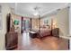 Luxurious main bedroom with a four-poster bed, dark wood floors, access to the pool, and an adjacent workspace at 424 Curry Ct, Altamonte Springs, FL 32714