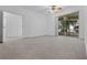 Bedroom features plush carpet, natural light, and an adjacent screened-in patio at 432 Valley View Dr, Winter Garden, FL 34787