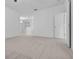 Bedroom featuring plush carpet, natural light, and an adjacent living area at 432 Valley View Dr, Winter Garden, FL 34787