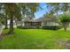 Large grassy backyard features a screened porch and mature landscaping for privacy at 432 Valley View Dr, Winter Garden, FL 34787