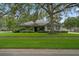 Charming single-story home featuring a spacious front yard with lush green grass and mature trees offering ample shade at 432 Valley View Dr, Winter Garden, FL 34787