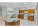 Bright kitchen featuring wood cabinets, white appliances, and a peninsula counter at 432 Valley View Dr, Winter Garden, FL 34787