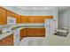Kitchen with oak cabinets and white appliances at 432 Valley View Dr, Winter Garden, FL 34787