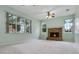 Inviting living room featuring a brick fireplace, carpet flooring, and large windows offering ample natural light and views at 432 Valley View Dr, Winter Garden, FL 34787