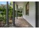 Covered porch with brick flooring, showcasing classic columns and a view of the home's well-maintained landscaping at 432 Valley View Dr, Winter Garden, FL 34787