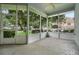 Relaxing screened porch with fan overlooks the landscaped yard and lush greenery at 432 Valley View Dr, Winter Garden, FL 34787