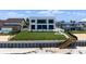 Elegant home featuring a pool, expansive lawn, and convenient beach access via private stairs for ultimate enjoyment at 4647 Van Kleeck Dr, New Smyrna Beach, FL 32169