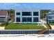 Modern home with a backyard oasis including a pool, lounge area, and steps to the beach, perfect for relaxation at 4647 Van Kleeck Dr, New Smyrna Beach, FL 32169