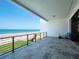 An oceanfront balcony with tile flooring, a metal railing, and a covered overhang offers stunning views of the beach and ocean at 4647 Van Kleeck Dr, New Smyrna Beach, FL 32169