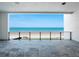 Expansive ocean-view balcony with tiled flooring and sleek metal railings, offering stunning views of the beach and the ocean at 4647 Van Kleeck Dr, New Smyrna Beach, FL 32169