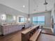 Spacious bathroom with dual vanities, a large soaking tub with an ocean view, and a walk-in shower at 4647 Van Kleeck Dr, New Smyrna Beach, FL 32169