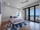 Stylish bedroom with ocean view, balcony access, and modern furnishings at 4647 Van Kleeck Dr, New Smyrna Beach, FL 32169