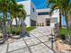 Striking modern home featuring a stylish patterned driveway, manicured lawn, and a unique architectural design at 4647 Van Kleeck Dr, New Smyrna Beach, FL 32169