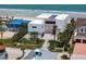 Beautiful aerial view of a modern beachfront home with lush landscaping at 4647 Van Kleeck Dr, New Smyrna Beach, FL 32169