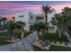 Contemporary home with a modern design, palm trees, and a patterned driveway at 4647 Van Kleeck Dr, New Smyrna Beach, FL 32169