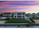 Beautiful contemporary home with a backyard pool, a large lawn, and private beach access at 4647 Van Kleeck Dr, New Smyrna Beach, FL 32169