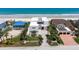 Elegant modern home with a manicured lawn, palm trees, and a stylish patterned driveway leading to a multi-car garage at 4647 Van Kleeck Dr, New Smyrna Beach, FL 32169
