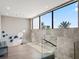 Hallway with modern lighting, glass railing, and large windows showcasing lush greenery at 4647 Van Kleeck Dr, New Smyrna Beach, FL 32169