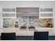 Modern kitchen with white cabinets, an island, and stainless steel appliances featuring a beautiful mosaic backsplash at 4647 Van Kleeck Dr, New Smyrna Beach, FL 32169