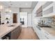 Sleek, modern kitchen with white cabinets, an island with seating, and stainless steel appliances and mosaic backsplash at 4647 Van Kleeck Dr, New Smyrna Beach, FL 32169