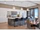 Modern kitchen featuring white cabinetry, a large island with seating, and pendant lighting and view of the ocean at 4647 Van Kleeck Dr, New Smyrna Beach, FL 32169