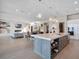 Open concept kitchen featuring a large island with seating and open to the living area with a fireplace at 4647 Van Kleeck Dr, New Smyrna Beach, FL 32169