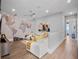 Bright living room with modern decor and a world map wall, extending into hallway at 4647 Van Kleeck Dr, New Smyrna Beach, FL 32169