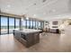 Spacious living area with ocean views featuring modern furniture and large windows, offering stunning natural light at 4647 Van Kleeck Dr, New Smyrna Beach, FL 32169