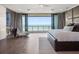 Spacious main bedroom features hardwood flooring, seating area, and ocean views at 4647 Van Kleeck Dr, New Smyrna Beach, FL 32169