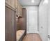 Mud room featuring custom storage cabinets, bench seating, and convenient coat hooks at 4647 Van Kleeck Dr, New Smyrna Beach, FL 32169