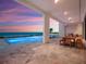 Spacious covered patio with dining area offering ocean views and access to the infinity pool at 4647 Van Kleeck Dr, New Smyrna Beach, FL 32169