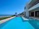 Inviting pool with built-in seating and ocean views at 4647 Van Kleeck Dr, New Smyrna Beach, FL 32169