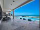 Stunning ocean view from covered patio with outdoor kitchen and infinity pool with bar seating at 4647 Van Kleeck Dr, New Smyrna Beach, FL 32169