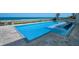 Sparkling pool featuring mosaic tiling, built-in seating, and picturesque ocean views at 4647 Van Kleeck Dr, New Smyrna Beach, FL 32169