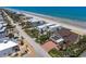 Charming street view of multiple houses near a beach, highlighting the manicured lawns and inviting neighborhood feel at 4647 Van Kleeck Dr, New Smyrna Beach, FL 32169