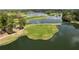 Aerial view showcasing a lush green golf course and serene lake views at 468 Alinole Loop, Lake Mary, FL 32746