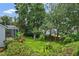 Lush backyard featuring well-maintained lawn and garden with direct access to the enclosed patio at 468 Alinole Loop, Lake Mary, FL 32746