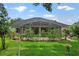 The home's backyard boasts a well-kept lawn, a garden, and a screened-in patio at 468 Alinole Loop, Lake Mary, FL 32746