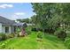 Beautiful backyard featuring a lush lawn, a garden area, and an enclosed patio at 468 Alinole Loop, Lake Mary, FL 32746